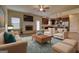 Inviting living room featuring a fireplace, ceiling fan, and an open concept to the modern kitchen at 1223 Hartwell Rd, Locust Grove, GA 30248