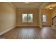 Open living space with wood floors, neutral walls, large window, and staircase to upper floor at 1223 Hartwell Rd, Locust Grove, GA 30248