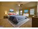 Comfortable bedroom with two matching side tables, a ceiling fan, and two TVs at 1223 Hartwell Rd, Locust Grove, GA 30248