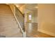Carpeted staircase with a dark wood railing leading to the upper levels of the home at 1223 Hartwell Rd, Locust Grove, GA 30248