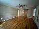 A bedroom features hardwood flooring, a ceiling fan, and a sliding barn door at 171 Knucklesville Rd, Rydal, GA 30171