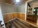 A cozy dining area features wood floors, wood paneled walls, and natural light flowing through the adjacent room at 171 Knucklesville Rd, Rydal, GA 30171