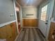 Mudroom entryway with wood walls, coat hooks, and a white front door at 171 Knucklesville Rd, Rydal, GA 30171