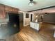 Spacious kitchen featuring hardwood floors, black appliances, and an island at 171 Knucklesville Rd, Rydal, GA 30171