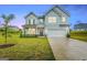 Two-story light blue house with a two-car garage and front yard at 1168 Bodega Loop, Locust Grove, GA 30248