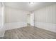 Cozy bedroom featuring wainscoting, neutral walls, wood-look flooring, and ample natural light at 770 Bridgewater Street Southwest W St, Atlanta, GA 30310