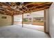 Unfinished interior with ceiling beams and flooring partially installed; large windows at the back at 1352 E Atlanta Rd, Stockbridge, GA 30281