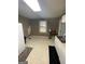 Bright kitchen with white cabinets and tile floors at 215 Sims St, Palmetto, GA 30268