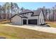 Three-car garage with a white and black exterior at 3059 Bold Springs Rd, Dacula, GA 30019