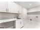 Laundry room with white cabinets and quartz countertop at 3063 Bold Springs Rd, Dacula, GA 30019