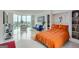 Bright bedroom showcasing floor-to-ceiling windows and sleeping area featuring an inviting orange comforter at 2870 Pharr Court South Nw Ct # 2703, Atlanta, GA 30305