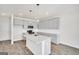 Bright kitchen featuring gray cabinets, granite countertops, stainless steel appliances, and wood-look flooring at 172 Weldon Rd # 19, Mcdonough, GA 30253