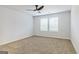 Spacious bedroom with plush carpet, a modern ceiling fan, and abundant natural light at 180 Weldon Rd # 21, Mcdonough, GA 30253