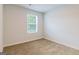 Empty bedroom with neutral carpet, a bright window, and a simple, clean design at 180 Weldon Rd # 21, Mcdonough, GA 30253