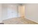 Clean bedroom featuring neutral carpet, double closets, and a door leading to another room at 180 Weldon Rd # 21, Mcdonough, GA 30253