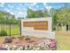 Attractive entrance to Campground Crossing community with colorful flowers and a glimpse of the playground at 180 Weldon Rd # 21, Mcdonough, GA 30253