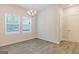 Bright dining area with wood-look floors and modern chandelier at 180 Weldon Rd # 21, Mcdonough, GA 30253