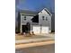 A two-story home features a gray exterior, white trim, a two-car garage, and a modern design at 180 Weldon Rd # 21, Mcdonough, GA 30253
