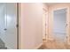 Bright hallway featuring white doors, neutral carpet, and access to various rooms in the home at 180 Weldon Rd # 21, Mcdonough, GA 30253