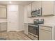 Modern kitchen with stainless steel appliances and gray wood cabinets at 180 Weldon Rd # 21, Mcdonough, GA 30253
