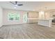 Open concept living space with gray wood flooring, large windows, and a kitchen view at 180 Weldon Rd # 21, Mcdonough, GA 30253