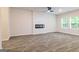 Living room with modern fireplace and light gray plank floors at 180 Weldon Rd # 21, Mcdonough, GA 30253