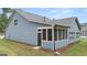 View of a house's back, highlighting a screened porch and neat lawn at 114 Airmont Dr, Sharpsburg, GA 30277