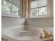 Relaxing bathroom featuring a soaking tub, and a large window at 2560 Almont Way, Roswell, GA 30076