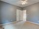 Gray bedroom with neutral carpet has double closets and door to hallway at 2560 Almont Way, Roswell, GA 30076