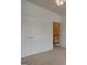 Neutral bedroom with white closets, door, and trim offers clean and classic space at 2560 Almont Way, Roswell, GA 30076