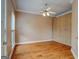 Bright bedroom featuring hardwood floors, crown molding, and built in storage at 2560 Almont Way, Roswell, GA 30076
