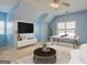 This bonus room has a ping pong table, modern furniture, and natural light at 2560 Almont Way, Roswell, GA 30076