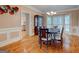 Formal dining room with hardwood floors, wainscoting, and a modern chandelier at 2560 Almont Way, Roswell, GA 30076
