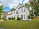 Beautifully landscaped home featuring a large yard with mature trees at 2560 Almont Way, Roswell, GA 30076