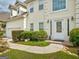 Well-maintained two story home features a two-car garage, manicured shrubs and a walkway at 2560 Almont Way, Roswell, GA 30076