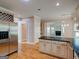 Gourmet kitchen features stainless refrigerator, granite countertops, light-colored cabinets, and hardwood floors at 2560 Almont Way, Roswell, GA 30076
