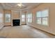 This bright, empty living room features a fireplace and large windows at 2560 Almont Way, Roswell, GA 30076