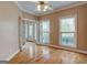 Bright living room with hardwood floors, crown molding, and double French doors leading to front door at 2560 Almont Way, Roswell, GA 30076