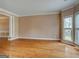 Spacious living room with gleaming hardwood floors, large windows, and neutral paint at 2560 Almont Way, Roswell, GA 30076