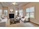 The living room features high ceilings, fireplace, and ample natural light streaming through large windows, creating a cozy ambiance at 2560 Almont Way, Roswell, GA 30076
