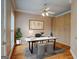 Cozy office with hardwood floors, built-in storage, a ceiling fan, and natural light at 2560 Almont Way, Roswell, GA 30076