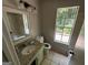 Bathroom with single vanity, toilet, and window overlooking backyard at 435 Ridgedale Way, Lawrenceville, GA 30044