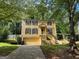 Two-story yellow house with a garage and landscaping at 435 Ridgedale Way, Lawrenceville, GA 30044