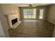 Living room with fireplace and vinyl flooring, and access to backyard at 435 Ridgedale Way, Lawrenceville, GA 30044