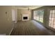 Living room with fireplace, vinyl flooring, and access to backyard at 435 Ridgedale Way, Lawrenceville, GA 30044