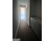 Long hallway with grey vanity and hardwood floors at 90 Austin Dr, Mcdonough, GA 30252