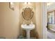 Elegant powder room with pedestal sink and ornate mirror at 348 Relative Trl, Mcdonough, GA 30253