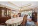 Formal dining room with large table, hutch, and hardwood floors at 348 Relative Trl, Mcdonough, GA 30253