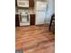 Kitchen area with white appliances and wood floor at 4403 Pinscher St, Union City, GA 30291