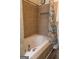 Bathroom with a jacuzzi-style bathtub with tile surround and a convenient shower niche at 2884 Mountbery Dr, Snellville, GA 30039
